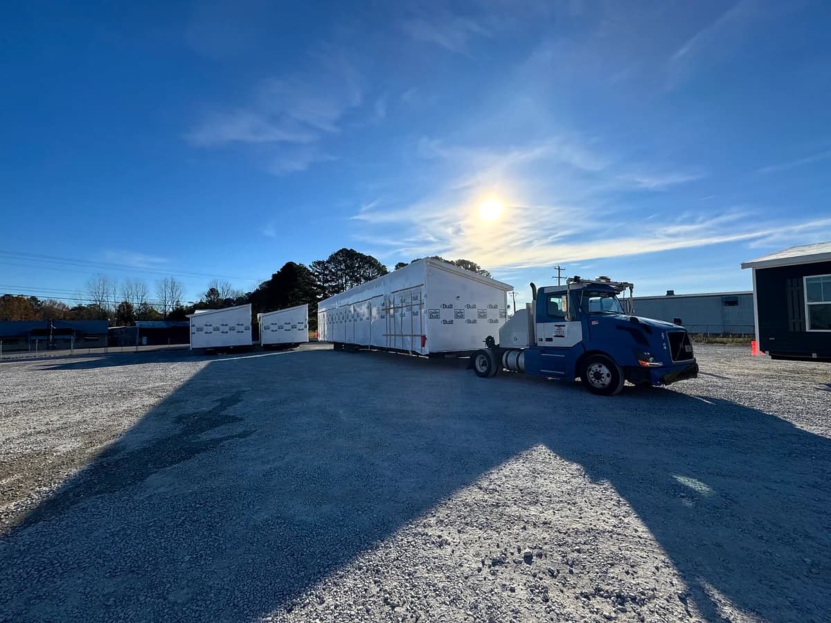 Trinity blue Volvo pulling an extra-long modern mobile home